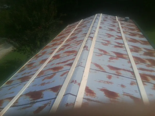 Rusted metal roof panels with new wood purlins before replacement — Storm Damage Roof Repair in White House by Roofing Brothers